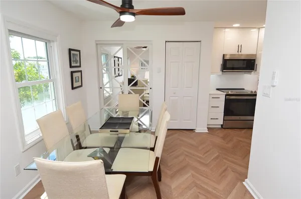 a dining room with furniture and a chandelier