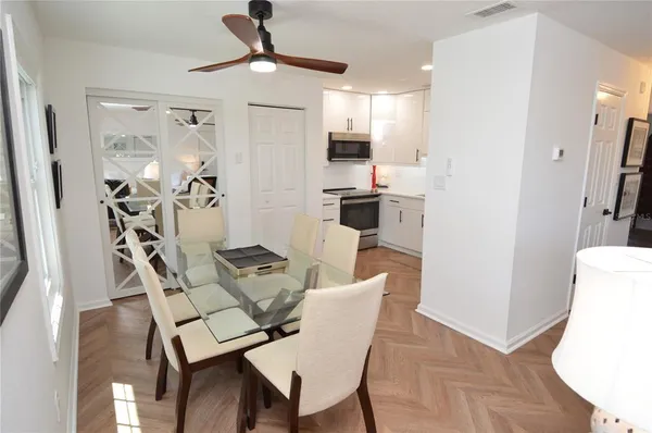 a kitchen with white cabinets and white appliances