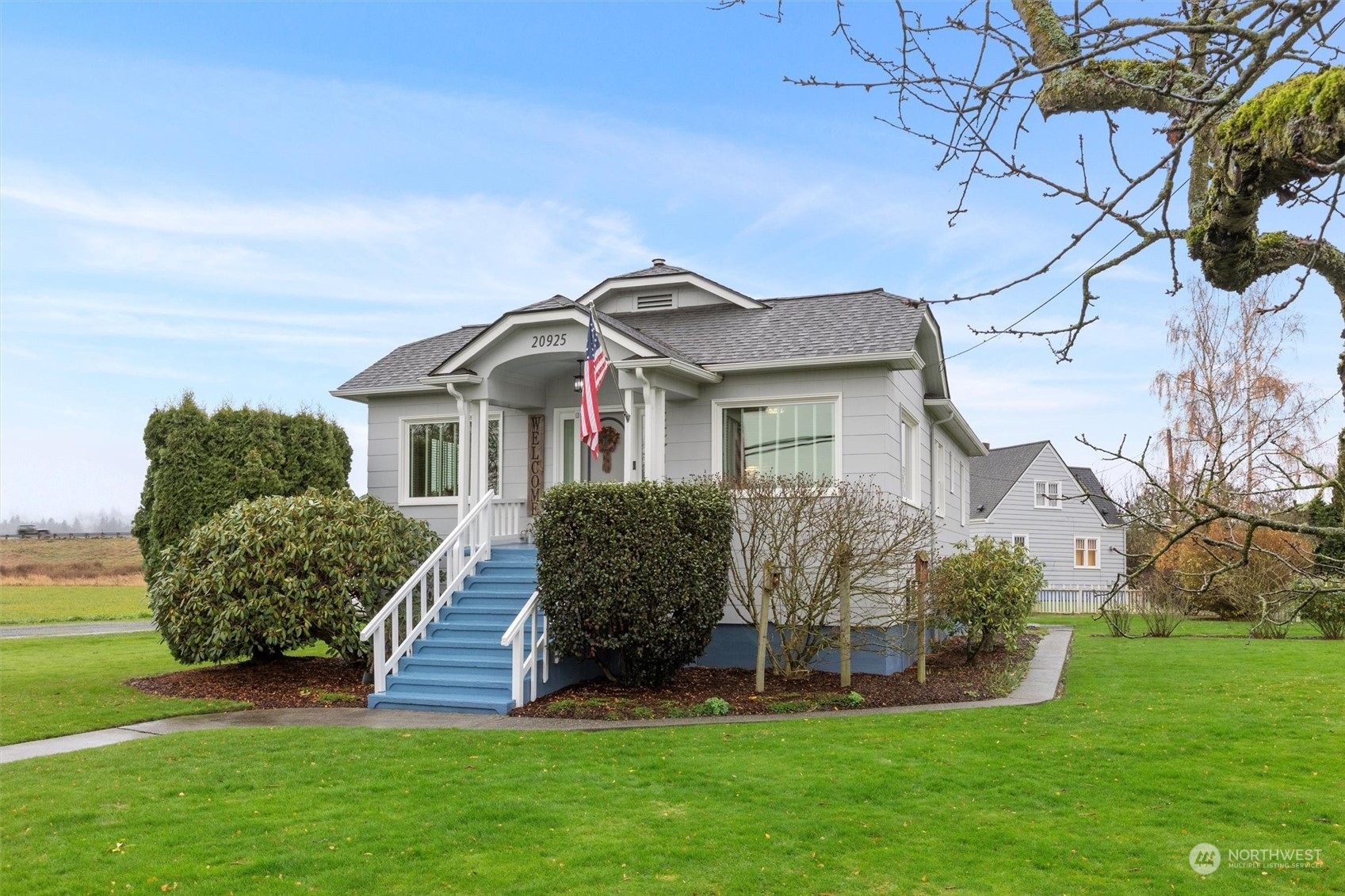 a front view of a house with a garden