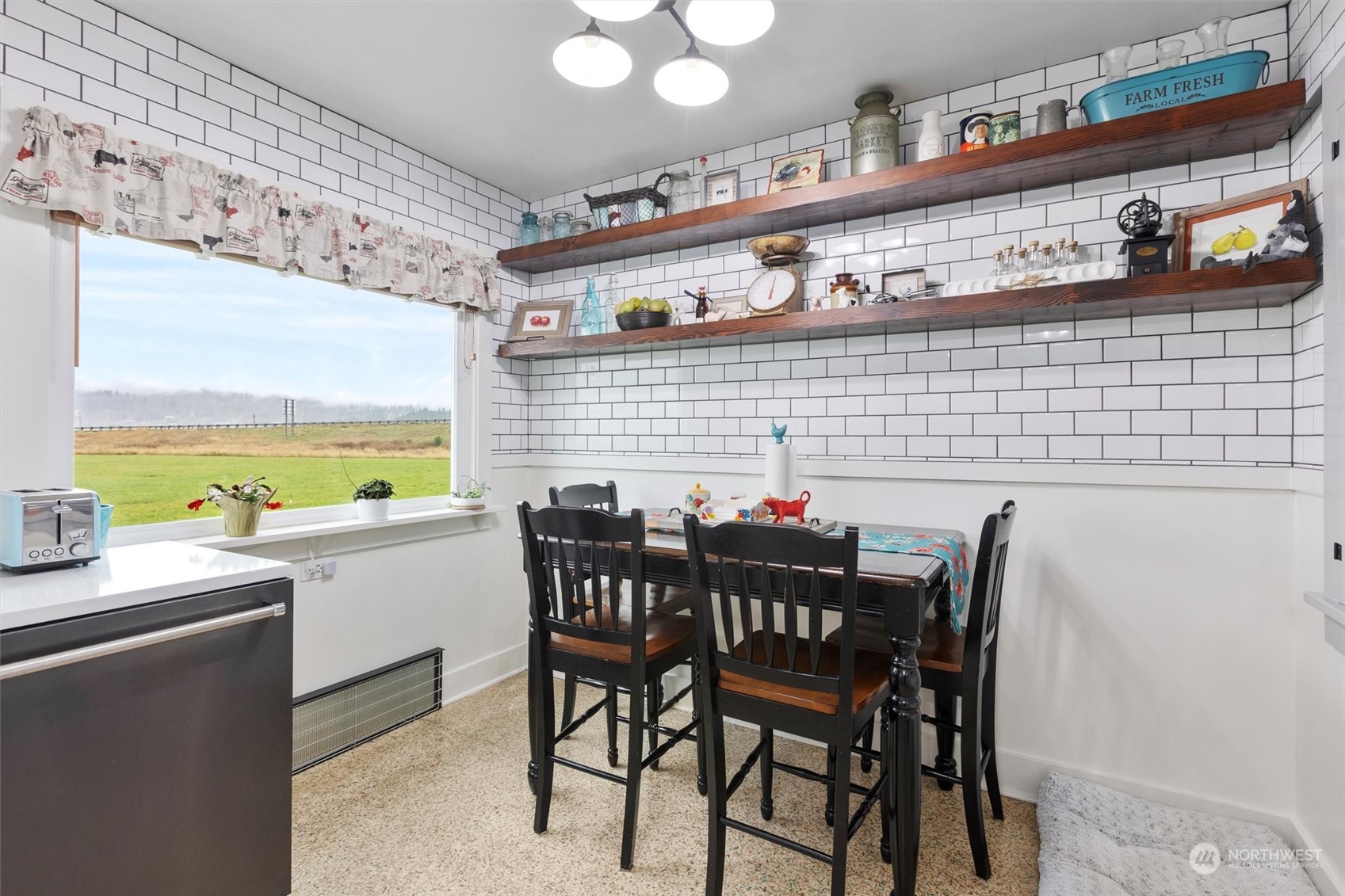 20925 Conway Frontage Road Mount Vernon, WA 98273 - Photo 15 of 40 a kitchen with stainless steel appliances a table and chairs in it