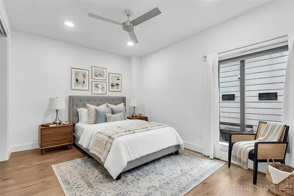 a bedroom with a bed and wooden floor