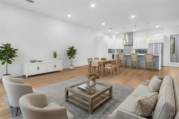 a living room with furniture and a potted plant