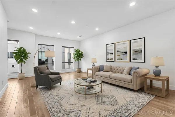 a living room with furniture and a wooden floor