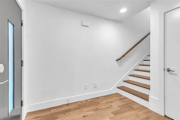 a view of a room with wooden floor and stairs