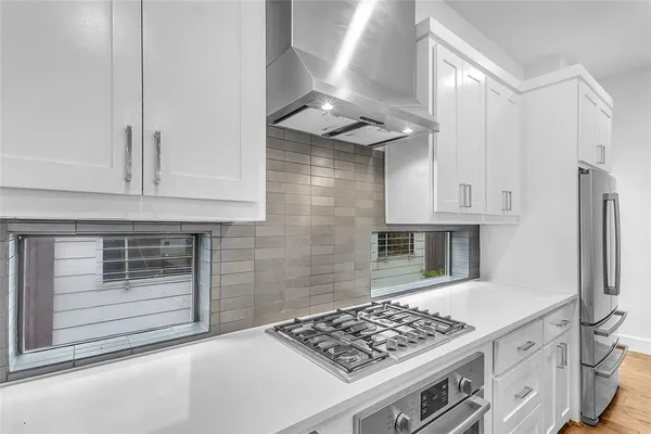 a kitchen with stainless steel appliances granite countertop a stove and a refrigerator