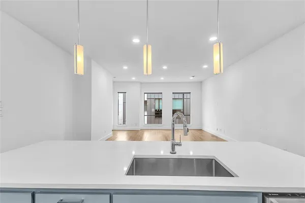 a kitchen with kitchen island a sink stainless steel appliances and cabinets