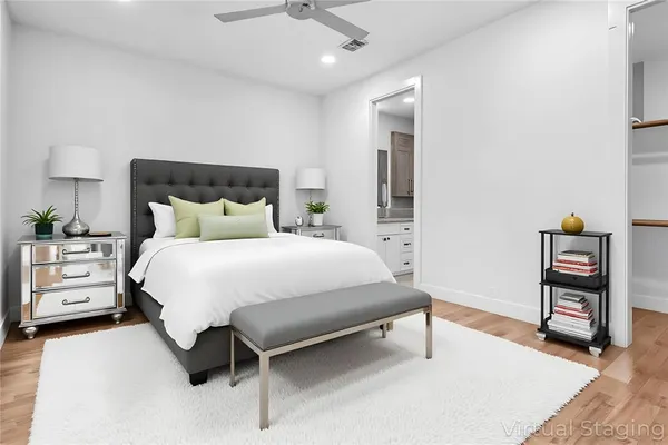 a bedroom with a bed and a night stand