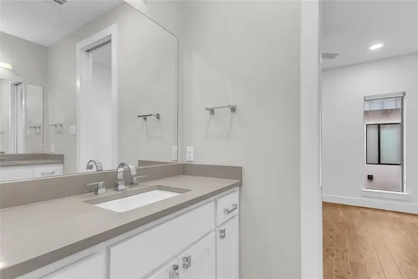 a bathroom with a sink double vanity and mirror
