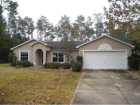 10331 Southwest 45th Avenue Ocala, FL 34476 - Photo 1 of 1 a front view of house with yard and trees