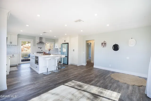 an empty room with fan and entrance