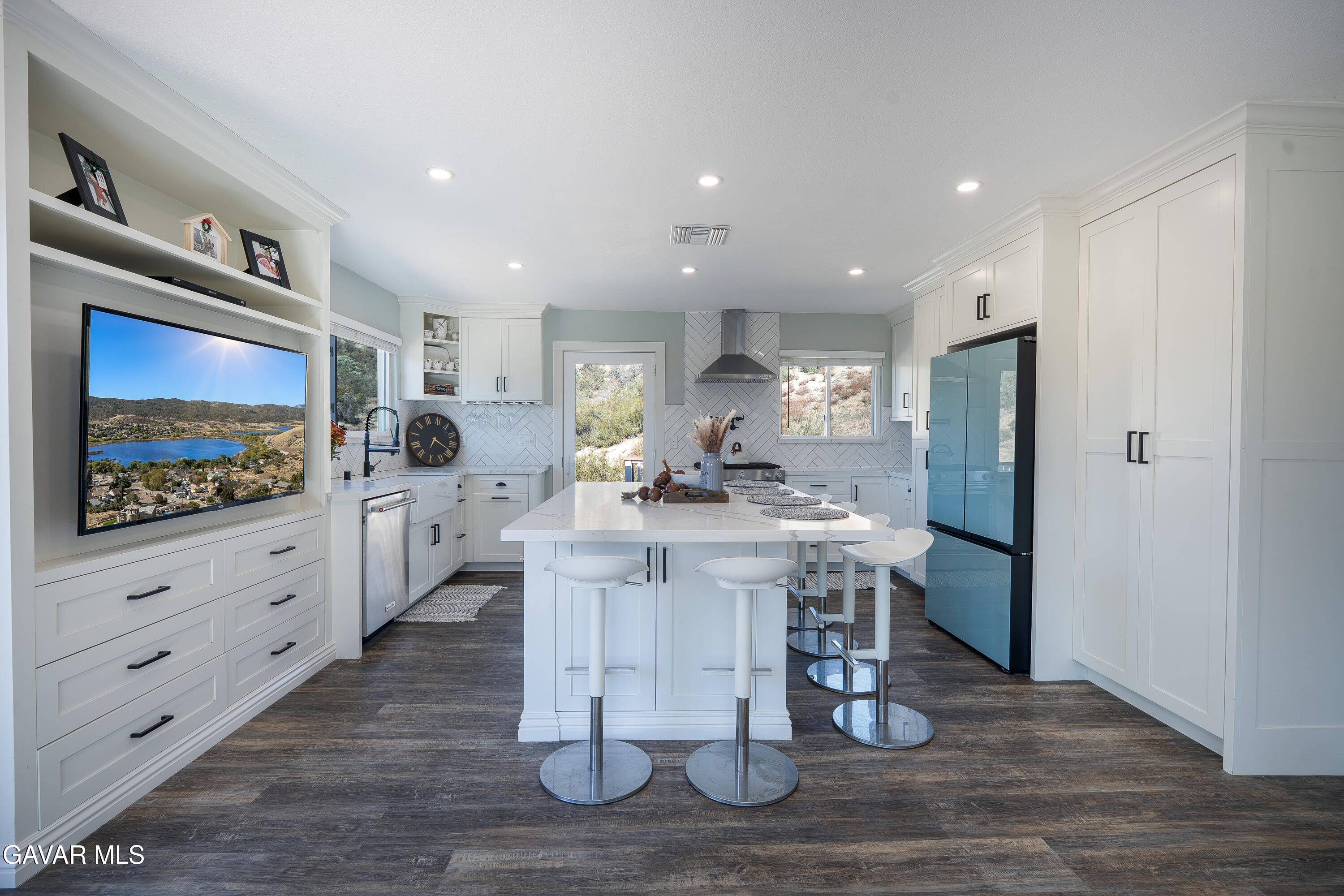 43379 Lookabout Road Lake Hughes, CA 93532 - Photo 38 of 50 a kitchen with stainless steel appliances kitchen island granite countertop a refrigerator a stove and a wooden floors