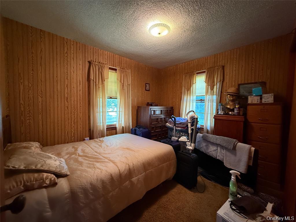 7 Dene Road Newburgh, NY 12550 - Photo 11 of 19 a bedroom with a bed and wooden furniture