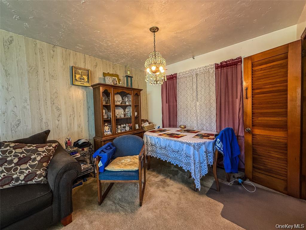 7 Dene Road Newburgh, NY 12550 - Photo 5 of 19 a bed room with a bed and a chandelier