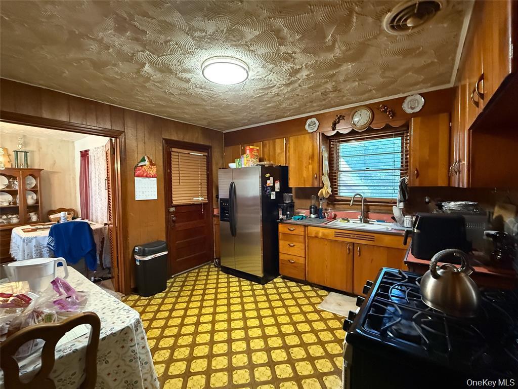7 Dene Road Newburgh, NY 12550 - Photo 6 of 19 a kitchen with blue cabinets and stainless steel appliances