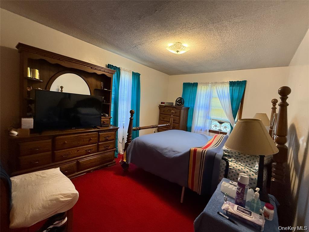 7 Dene Road Newburgh, NY 12550 - Photo 7 of 19 a bedroom with furniture and a flat screen tv