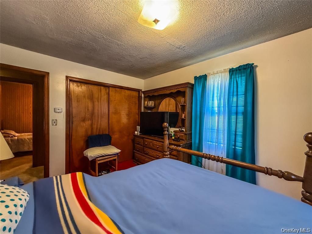 7 Dene Road Newburgh, NY 12550 - Photo 8 of 19 a bedroom with furniture and a large window