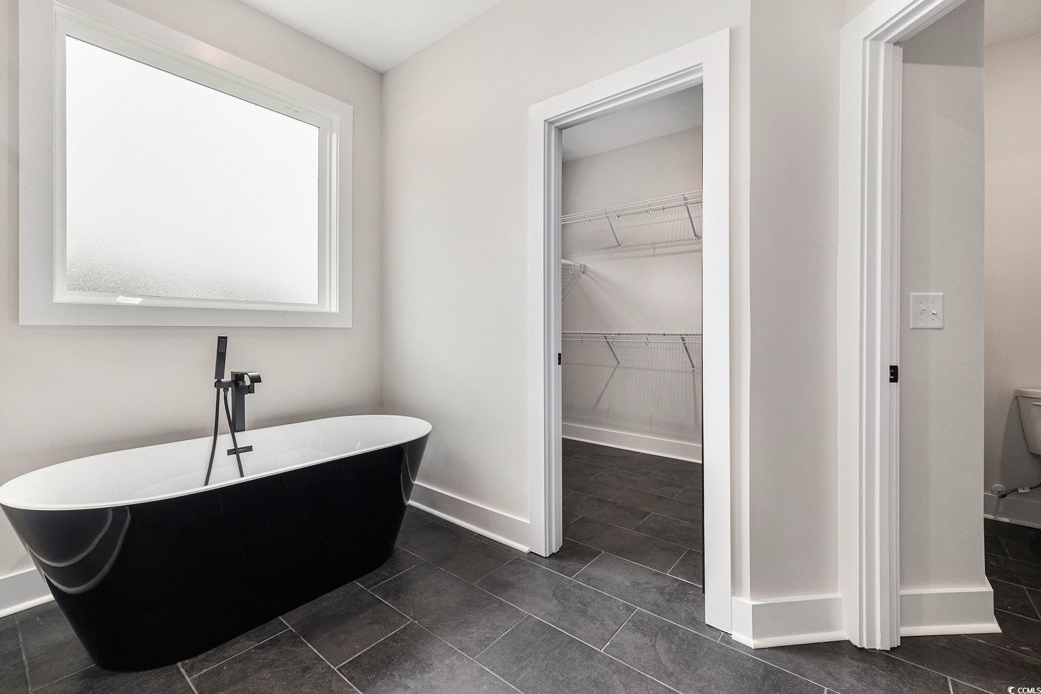 1052 Merritt Road Conway, SC 29526 - Photo 24 of 33 Full bath featuring a soaking tub, baseboards, and