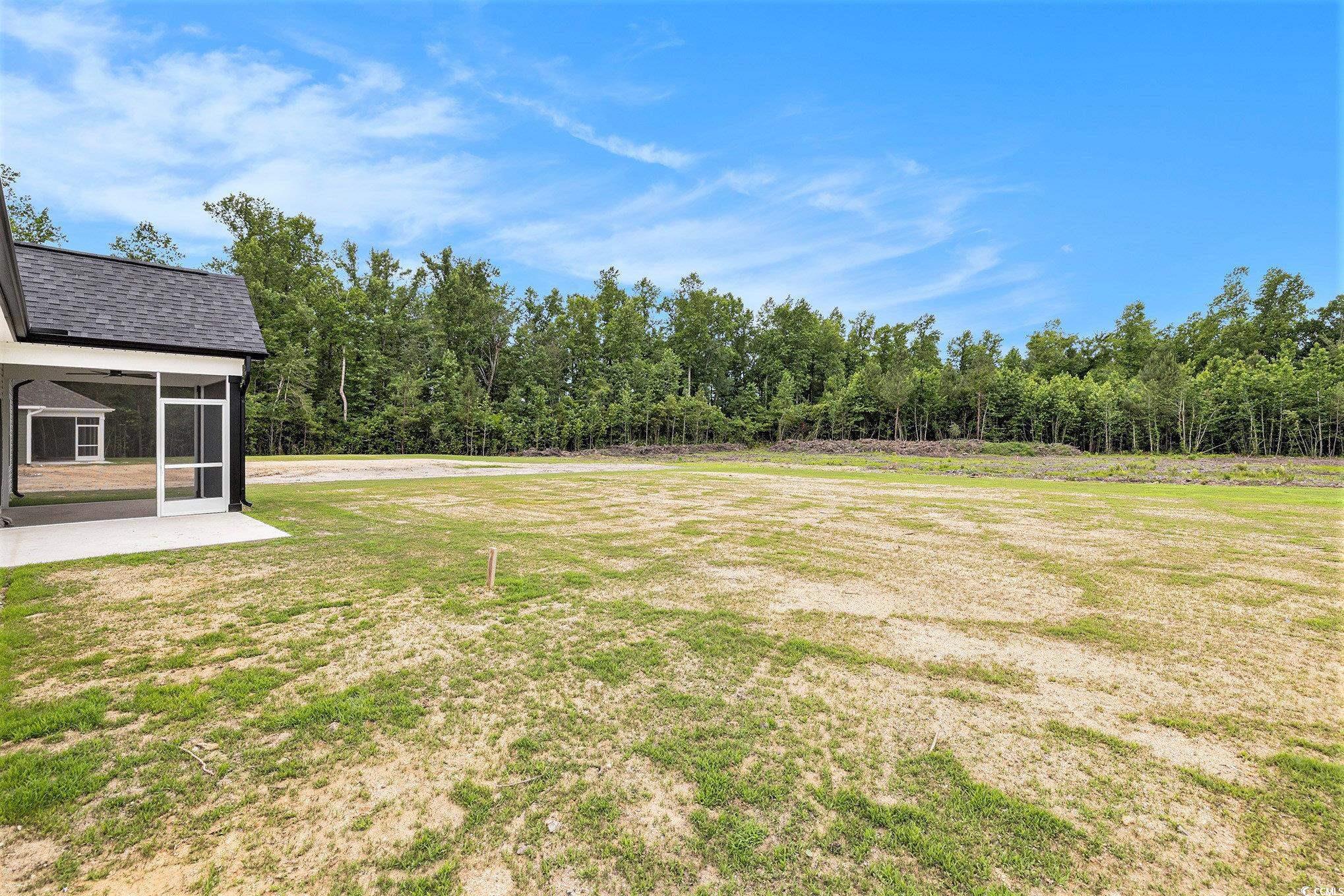 1052 Merritt Road Conway, SC 29526 - Photo 29 of 33 View of green lawn featuring a sunroom and a view