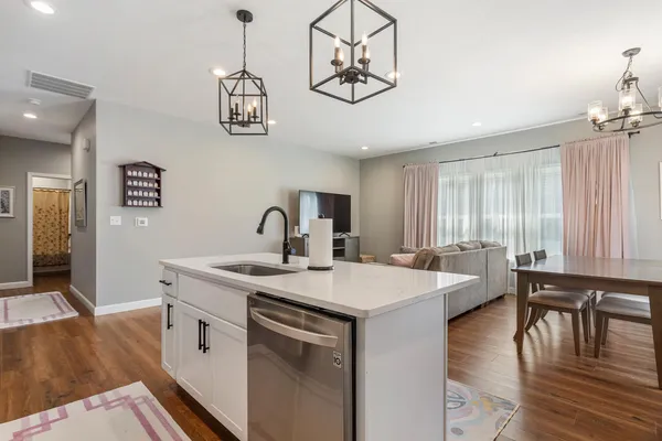 a view of a a dining room with furniture window and wooden floor