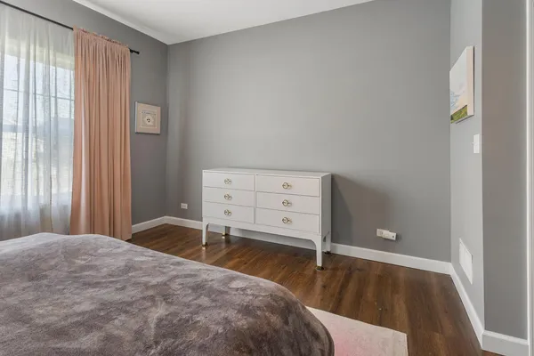 a bedroom with a bed and a desk