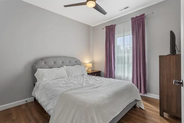 a bedroom with a bed and a chandelier