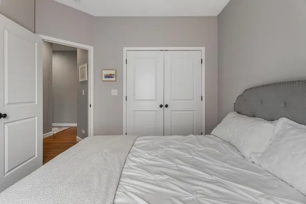 a bedroom with a bed and a mirror