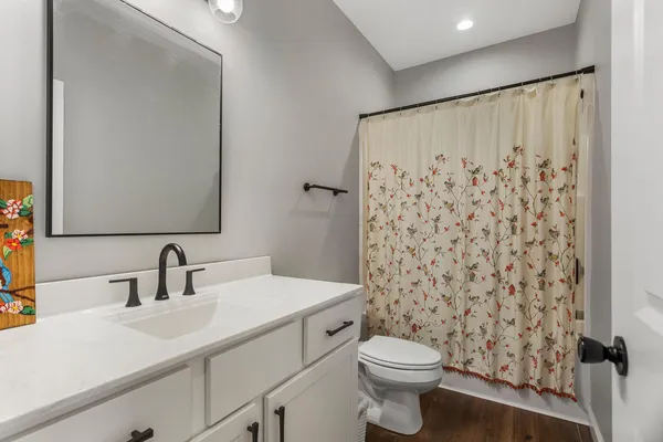 a bathroom with a sink toilet and shower