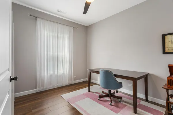 a view of a workspace with furniture and a window
