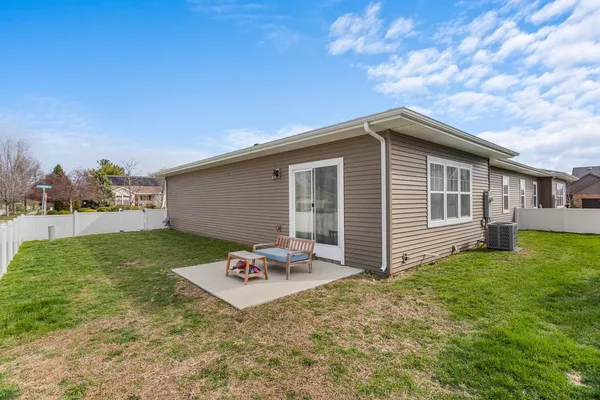 a backyard of a house with table and chairs