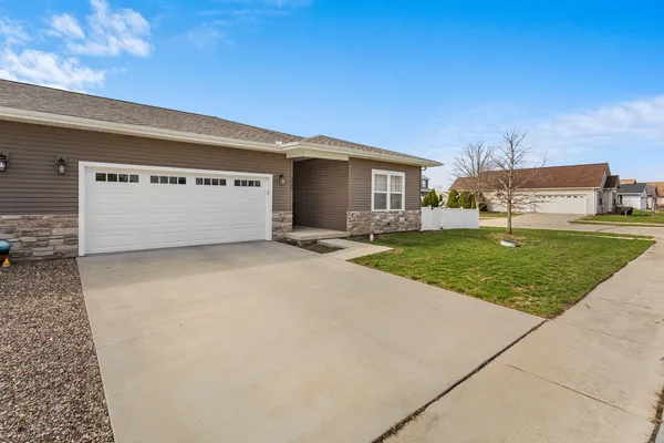 a view of a house with a yard and garage