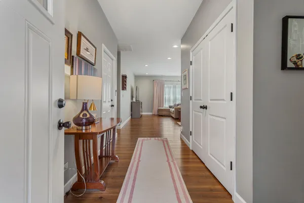 a view of a hallway with wooden floor and staircase