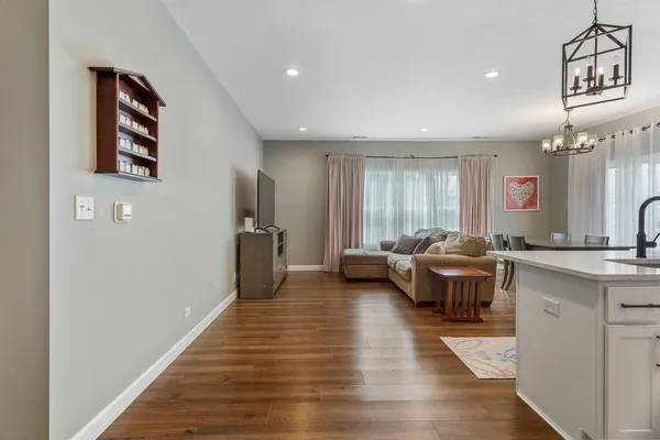 a living room with furniture and a chandelier