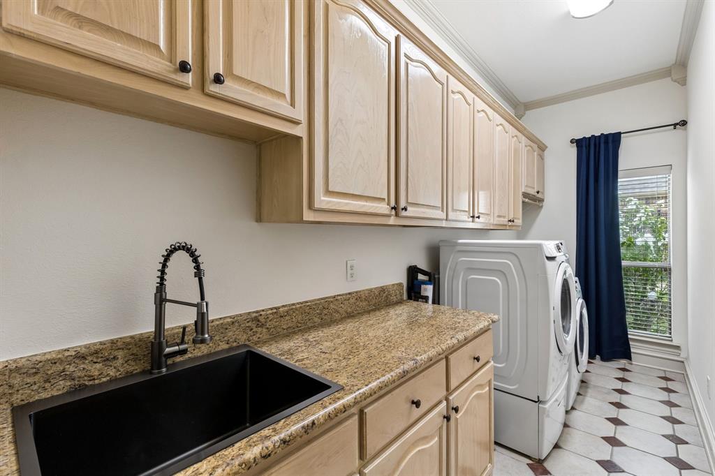 8517 Navigation Drive Rowlett, TX 75088 - Photo 27 of 39 a kitchen with stainless steel appliances granite countertop a sink and cabinets