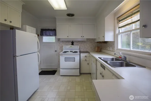 a kitchen with a refrigerator sink and cabinets