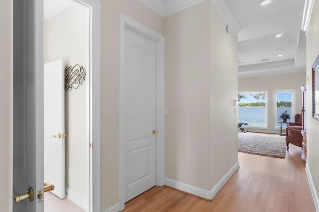 a bedroom with a bed and a lamp on dresser