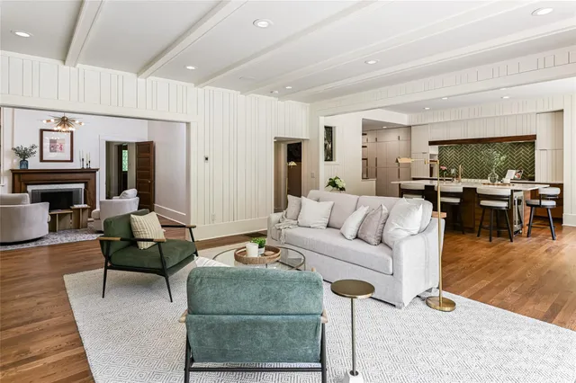 a living room with furniture wooden floor and a flat screen tv
