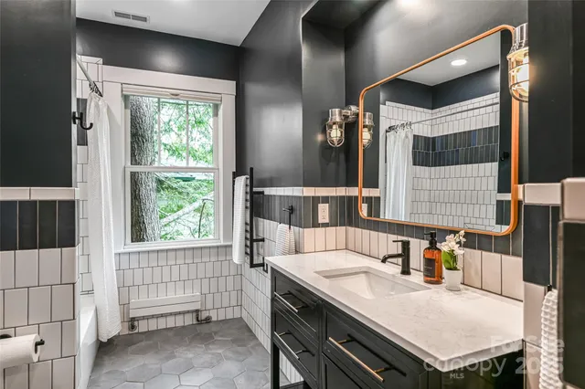 a kitchen with a stove a refrigerator and a sink