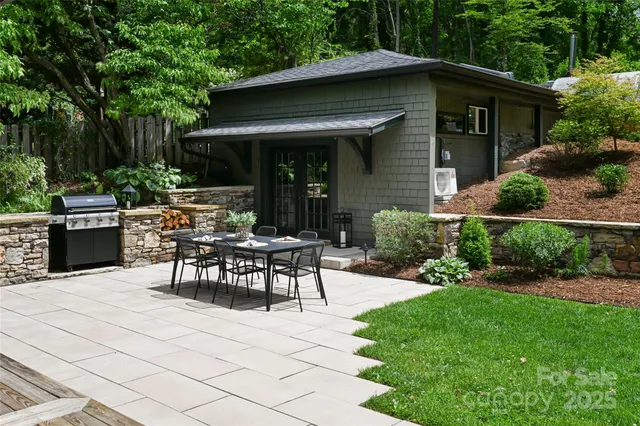 a view of a house with backyard sitting area and garden