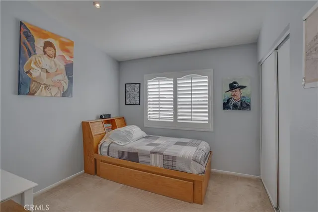 a bedroom with a bed and window