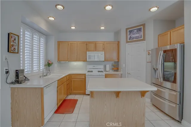 a kitchen with a sink a stove a refrigerator and cabinets