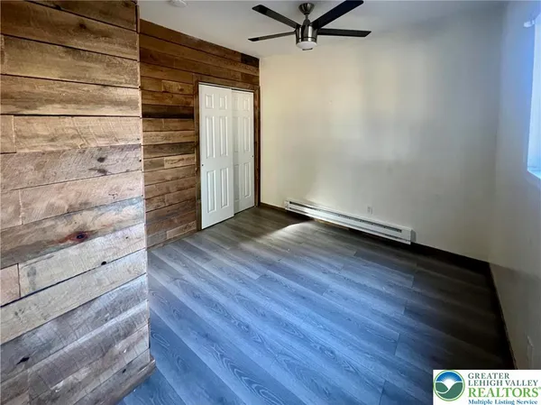 a view of a room with wooden floor