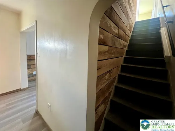 a view of entryway with wooden floor and stairs