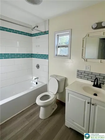 a bathroom with a sink toilet a mirror and shower