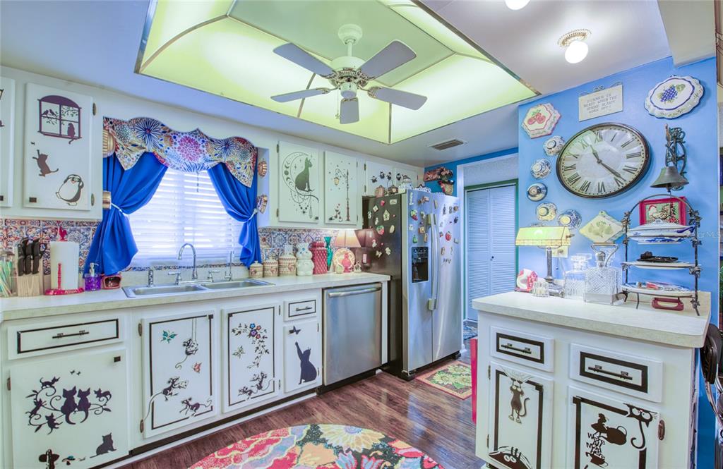 7040 Cognac Drive, Unit 3 New Port Richey, FL 34653 - Photo 16 of 31 a very nice looking open kitchen with stainless steel appliances granite countertop a stove a sink and a chandelier