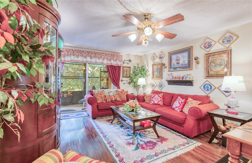 7040 Cognac Drive, Unit 3 New Port Richey, FL 34653 - Photo 17 of 31 a living room with fireplace furniture and a large window