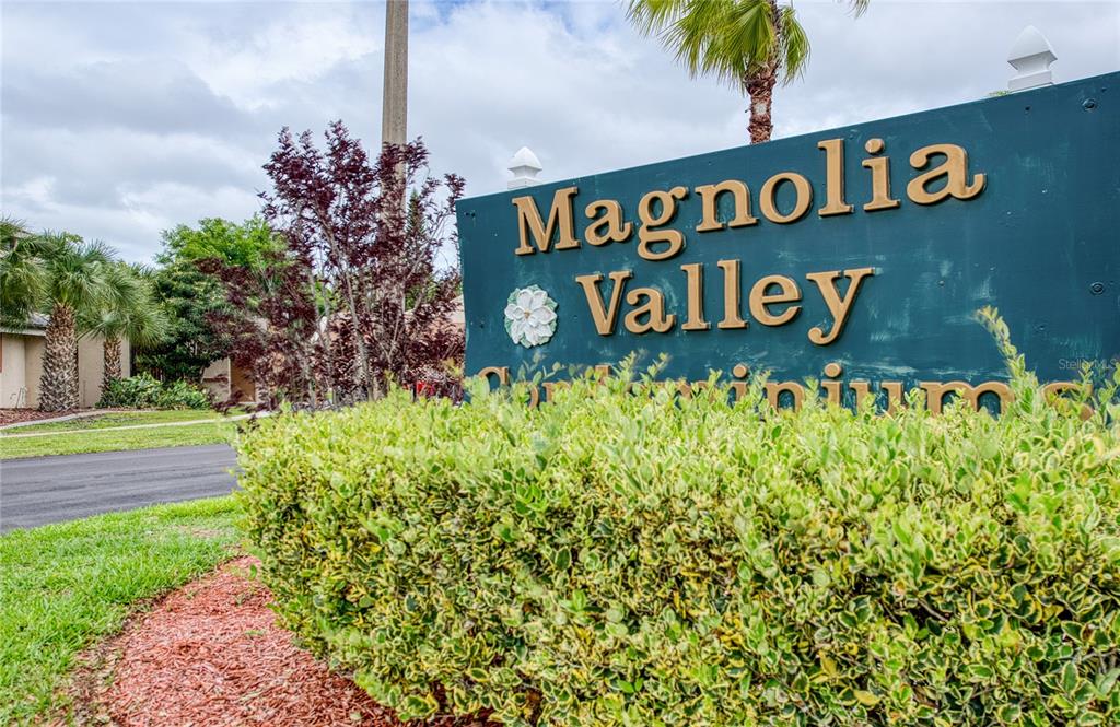 7040 Cognac Drive, Unit 3 New Port Richey, FL 34653 - Photo 2 of 31 a street sign that is sitting on a brick wall