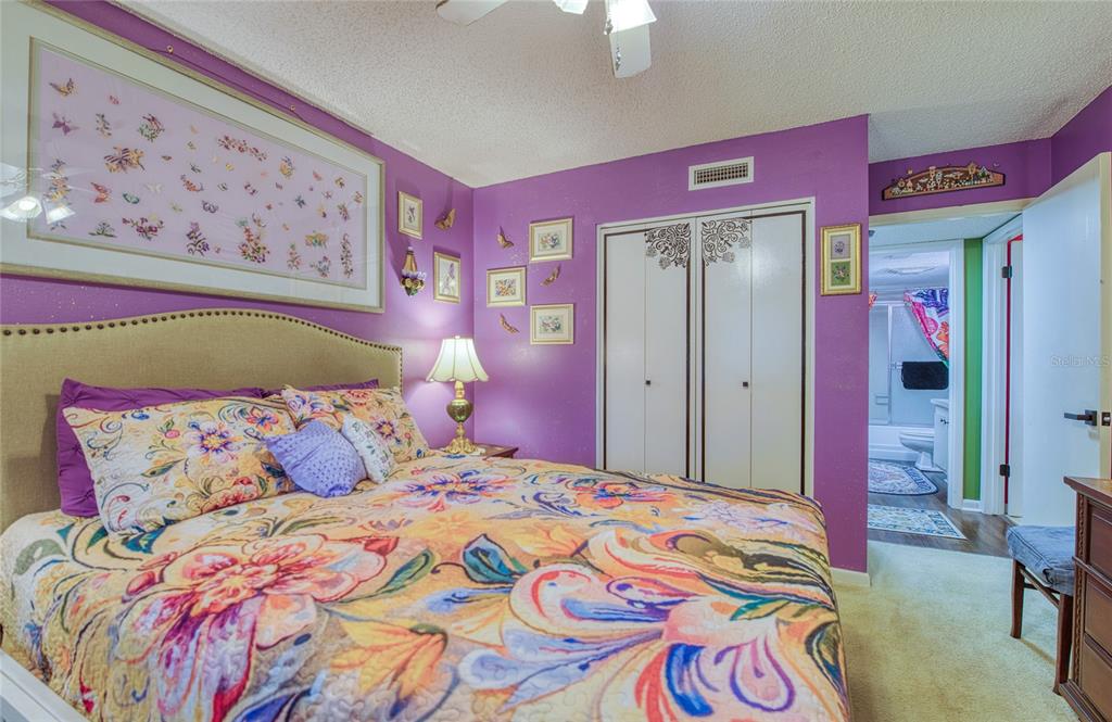 7040 Cognac Drive, Unit 3 New Port Richey, FL 34653 - Photo 22 of 31 a bedroom with a bed and a painting on the wall