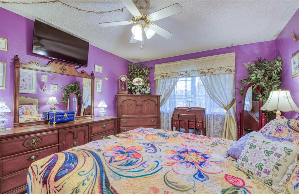 7040 Cognac Drive, Unit 3 New Port Richey, FL 34653 - Photo 23 of 31 a bedroom with a bed and a flat screen tv