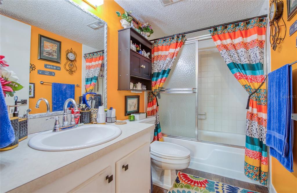 7040 Cognac Drive, Unit 3 New Port Richey, FL 34653 - Photo 24 of 31 a bathroom with a sink a toilet and shower curtain