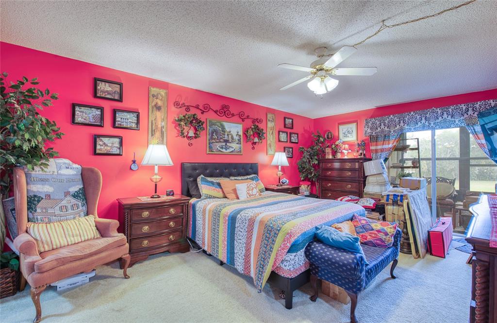 7040 Cognac Drive, Unit 3 New Port Richey, FL 34653 - Photo 27 of 31 a bedroom with a bed and a chandelier